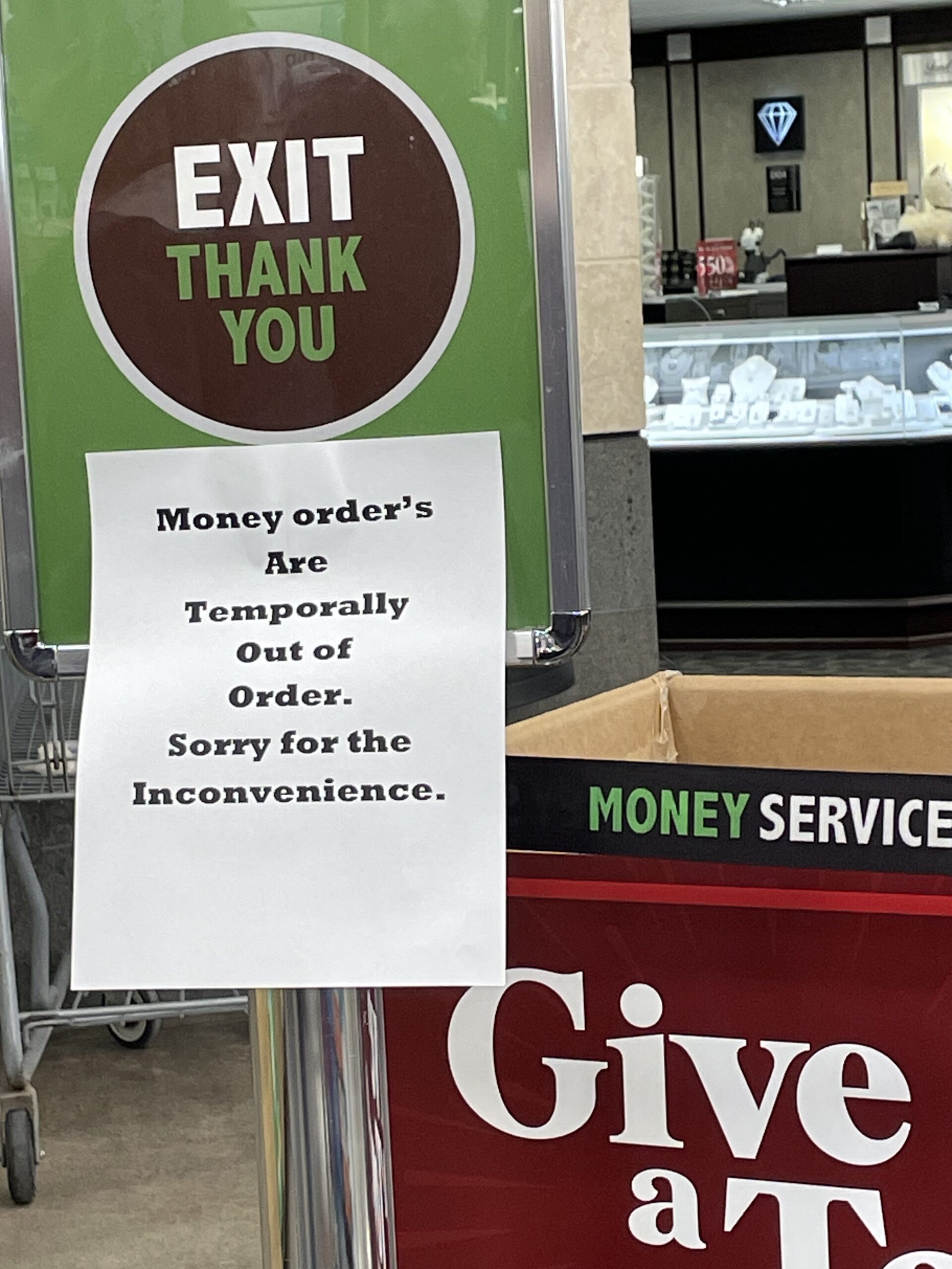 Sign in store that says: Money order's/ Temporally/Out of/Order./Sorry for the/Inconvenience
